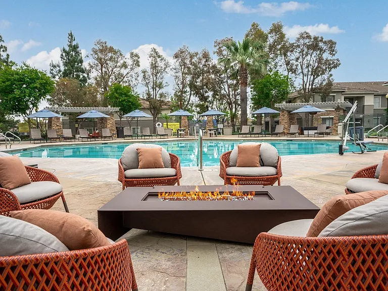 Poolside Fire Pit Lounge with Cushioned Seating and Resort-Style Views