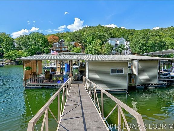 Great dock with roll down shades, Wet Steps ladder and dive, TV, fans, covered seating area, storage unit, and an awesome kitchen/bar area!