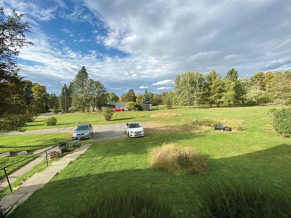 View of parking area and front gardens from living room