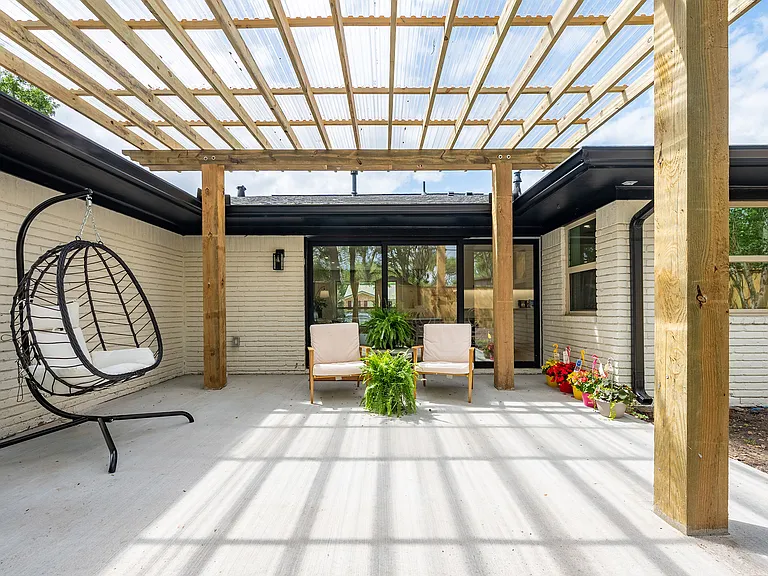 Inviting patio space, ideal for outdoor dining and year-round enjoyment, overlooking a spacious backyard with fresh landscaping and plenty of room for outdoor living, play, or gardening.