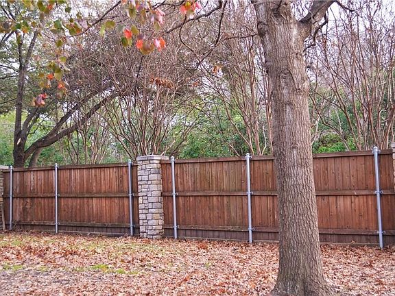 The property is surrounded by Desirable, Mature Trees. The Durable, Handcrafted fence is made of stone and wood!