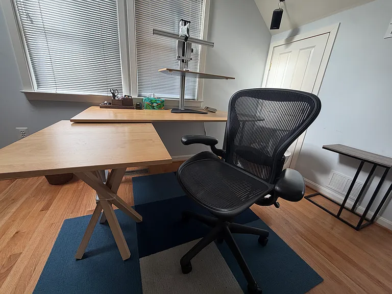 Large desk includes Herman Miller Aeron chair and an adjustable standing desk