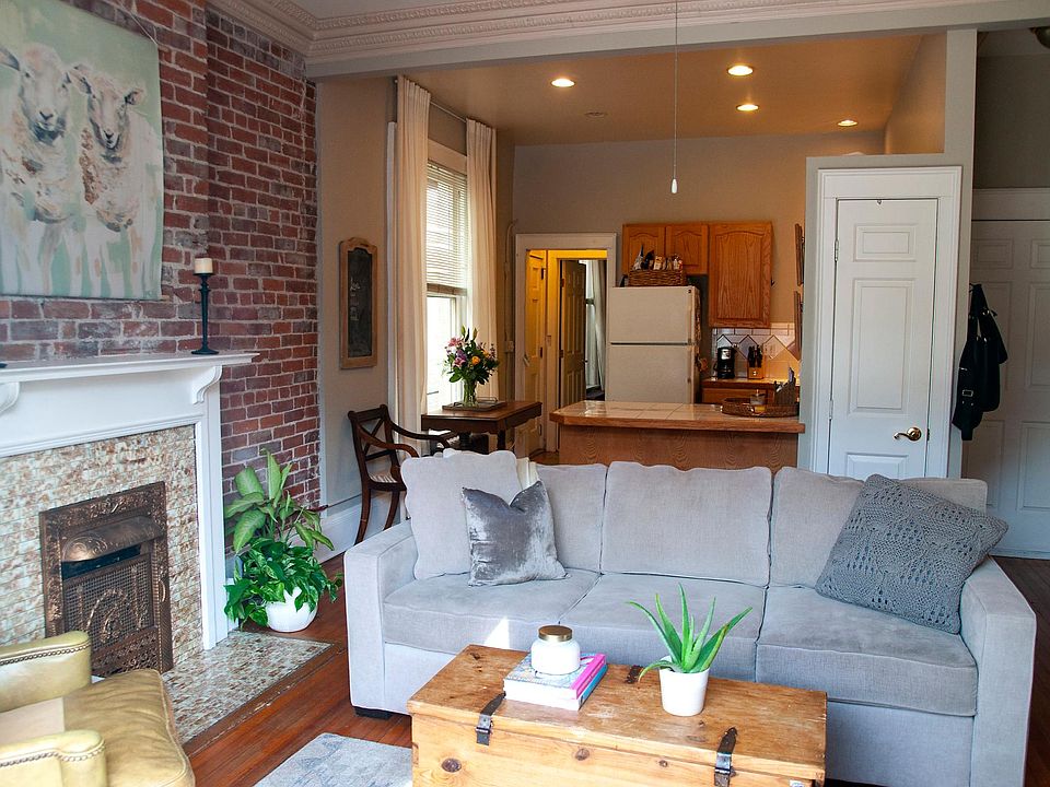 Open floor plan, living room, kitchen, and fireplace.