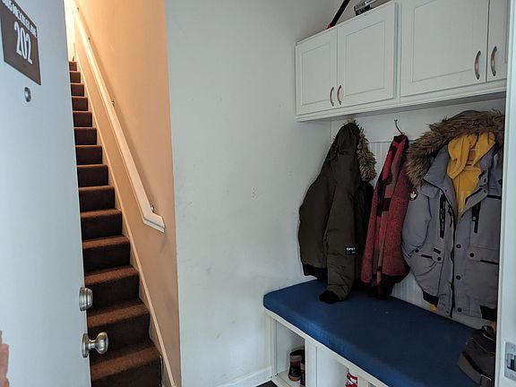 Entryway with stairs that go immediately upstairs.