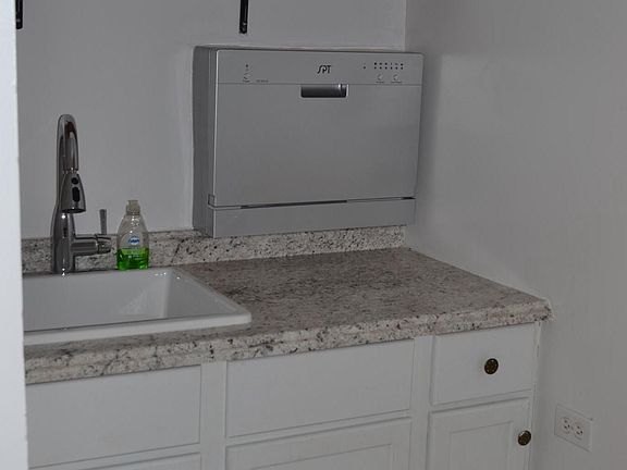 Renovated kitchen with countertop dishwasher. 