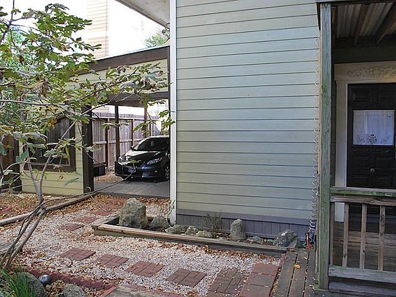 View of covered parking that is available.  Pathway leads into tranquil back yard and private ear entrance.