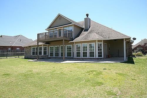 Back of home with wall of windows.