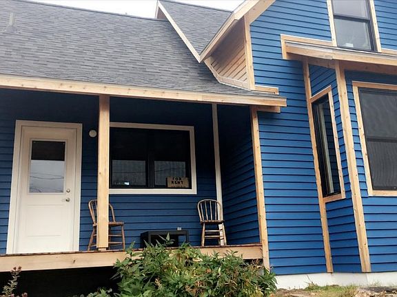 Entry into kitchen off of your private porch. The well insulated home is currently being stained blue with white trim.