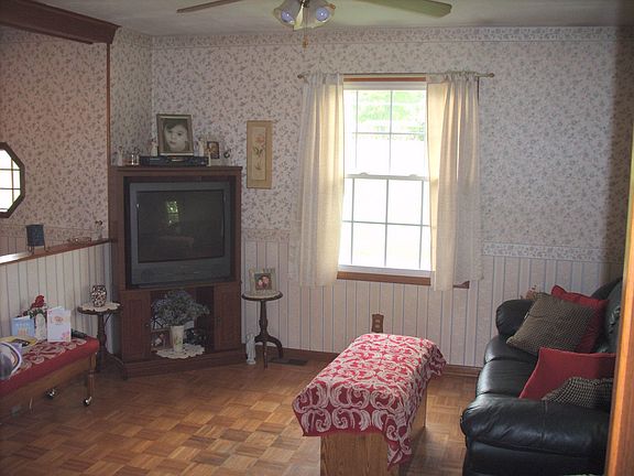 Featuring wood parque flooring, ceiling fan. & newer vinyl tilt in windows.