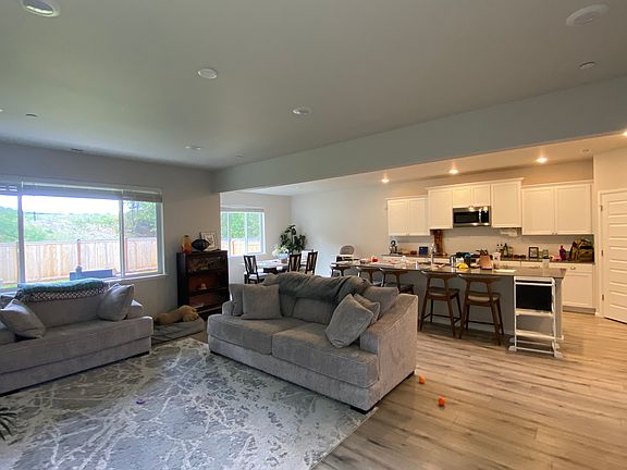 Open living space: living room, kitchen, dining room. Large cozy couches, with many kitchen ammentities