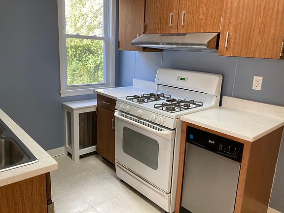 Kitchen with dishwasher, garbage disposal, 4 burner gas stove and oven and full size refrigerator/freezer.