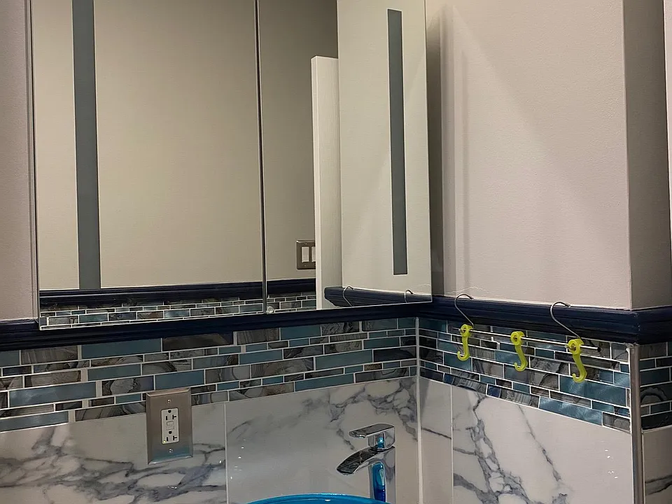 vanity with LED mirror and waterfall faucet