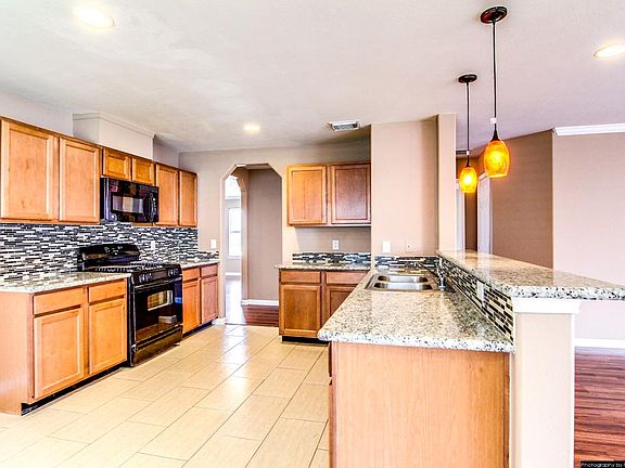 Granite counters, mosaic tile backsplash, new appliances, recess lighting, what more could you want?!