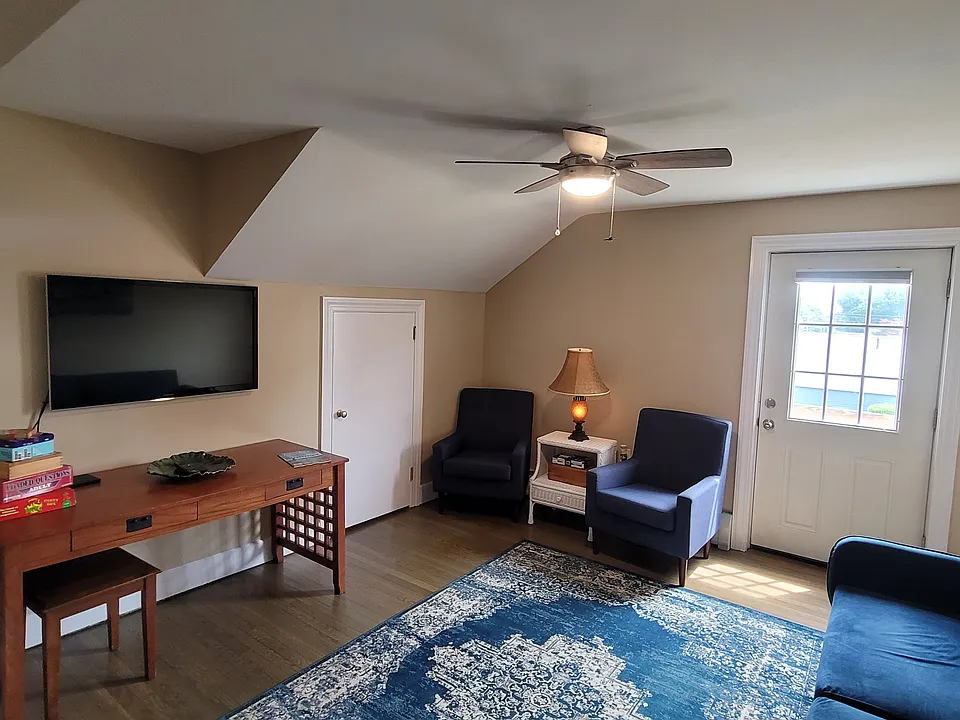 Large living room with door to small balcony, and large storage closet