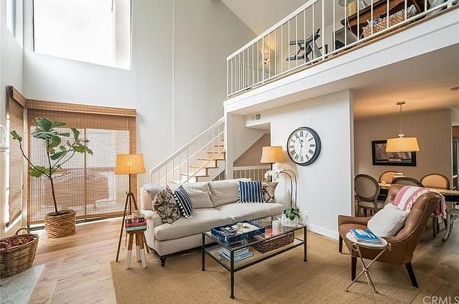 Main living space has sky-high ceilings, lots of natural light.