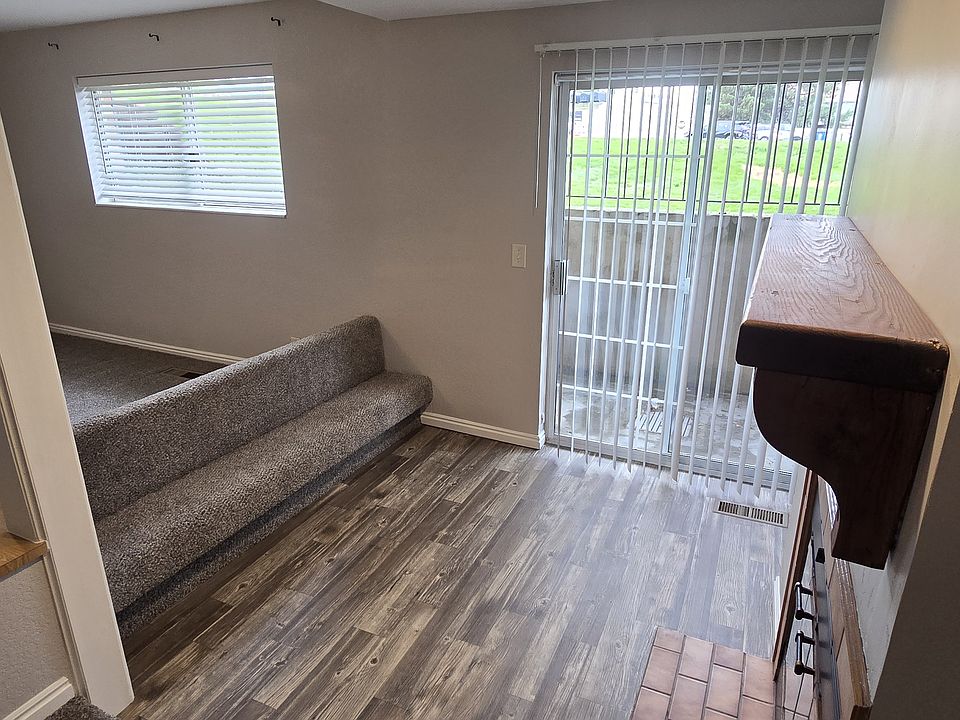Built-in seating in front of fireplace; lots of natural light through sliding glass door leading to private patio area