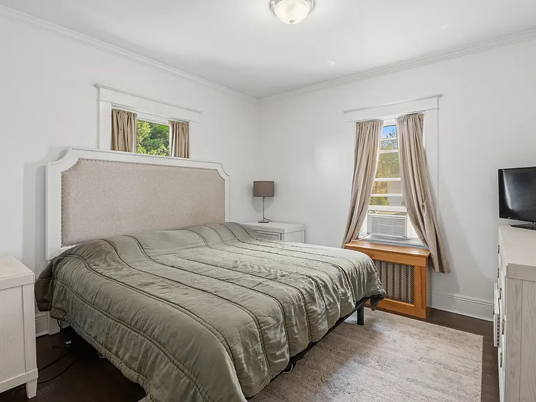 Bright primary bedroom facing the backyard