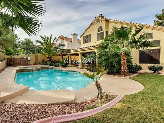 Backyard paradise with pool and spa, huge covered patio and mature landscape...