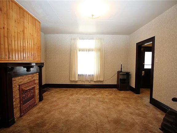 Large 14x14 Living Room w/ Decorative Fireplace offering Ceramic Tile Front, Beautiful Wood Trim Work and plenty of Natural Ligh