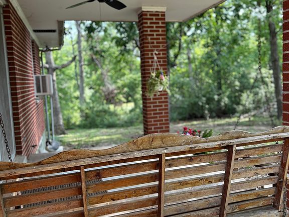 Porch swing looking out into woods with so much nature to watch!