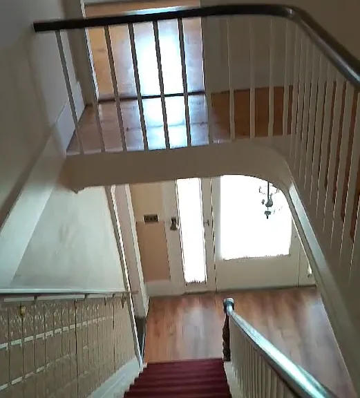 staircase with master bedroom in the background