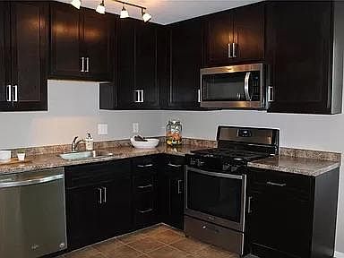 Stainless steel appliances and beautiful 42_ cabinets.