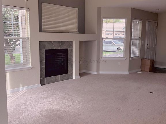 Living Room, Gas fireplace, Large private patio with concrete area, pea gravel plus privacy wall enclosure and gate access.