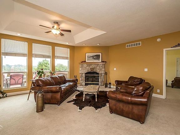 Main level family room with wood burning fireplace! Lots of windows for amazing view of property!