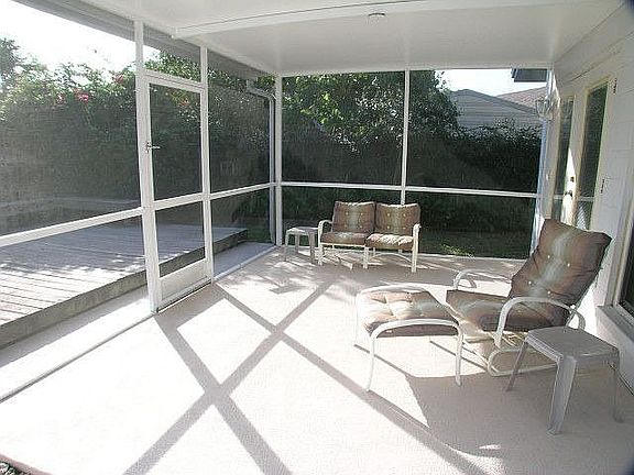 Screened Lanai opens to pool