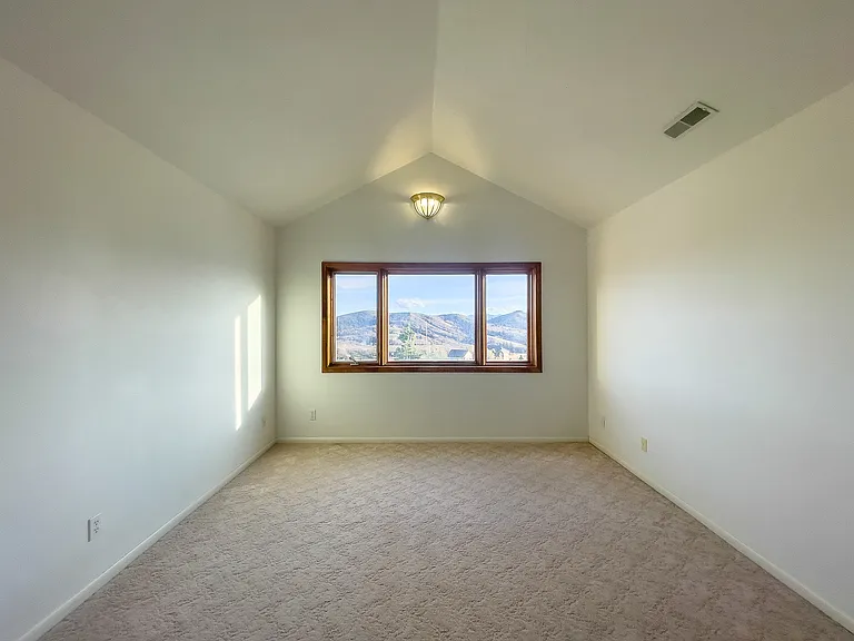 Upstairs bedroom #2, with vaulted ceiling and gorgeous mountain views.