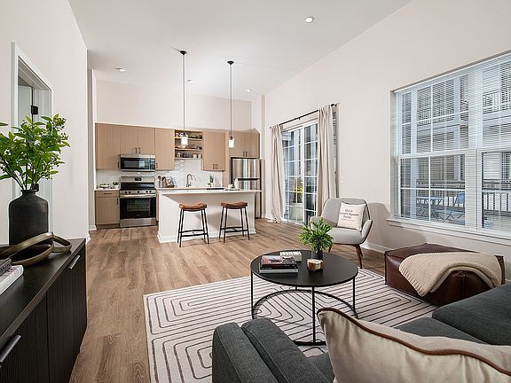 Experience the elegance of this open-concept living area featuring chic design and abundant natural light.