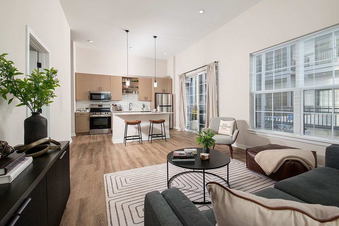 Experience the elegance of this open-concept living area featuring chic design and abundant natural light.