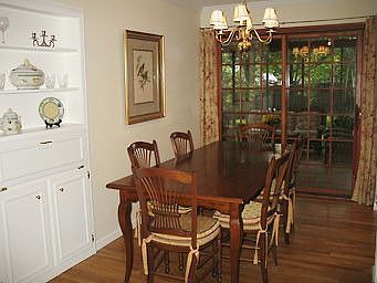 Dining room with built-in and large, paned sliding doors to screened porch