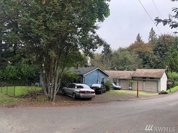 Fenced front yard on corner, blue house