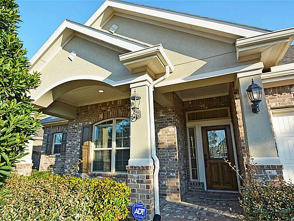 A covered front porch welcomes you home. Leaded glass door entry, beautiful architecture and front elevation of the home.