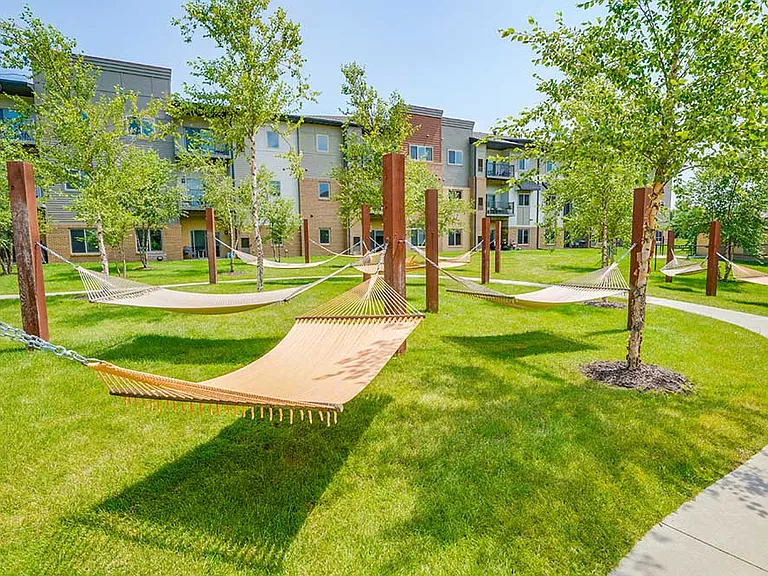 Unwind in the hammock garden, a peaceful retreat surrounded by greenery and shaded walking paths.
