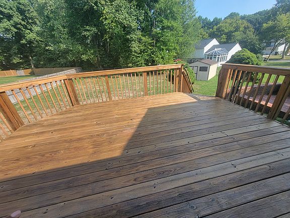 Over-sized deck and backyard view. Shed for storage use.