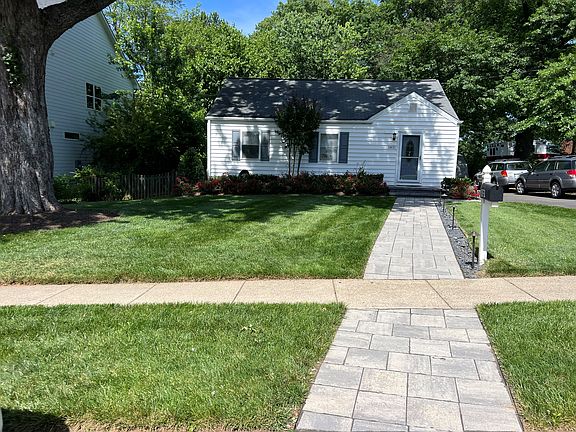 Front Yard View with Paver Walkway and Night Lighting