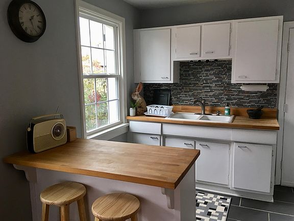 Spacious kitchen with butcher block countertops.