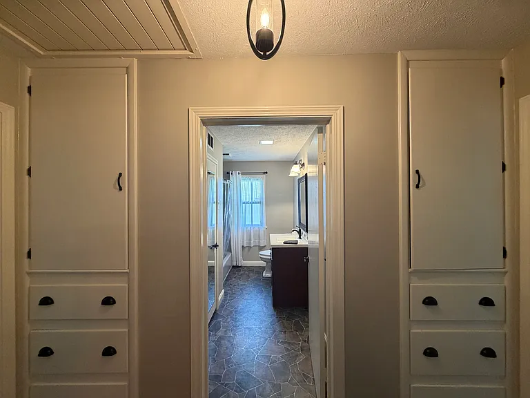 Hallway built-in storage cabinets with drawers, outside of two bedrooms and full bathroom.