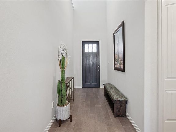 Entryway with a high ceiling and wood finished floors