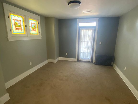 Dining room with door to exterior rear deck. Please notice the stained glass.
