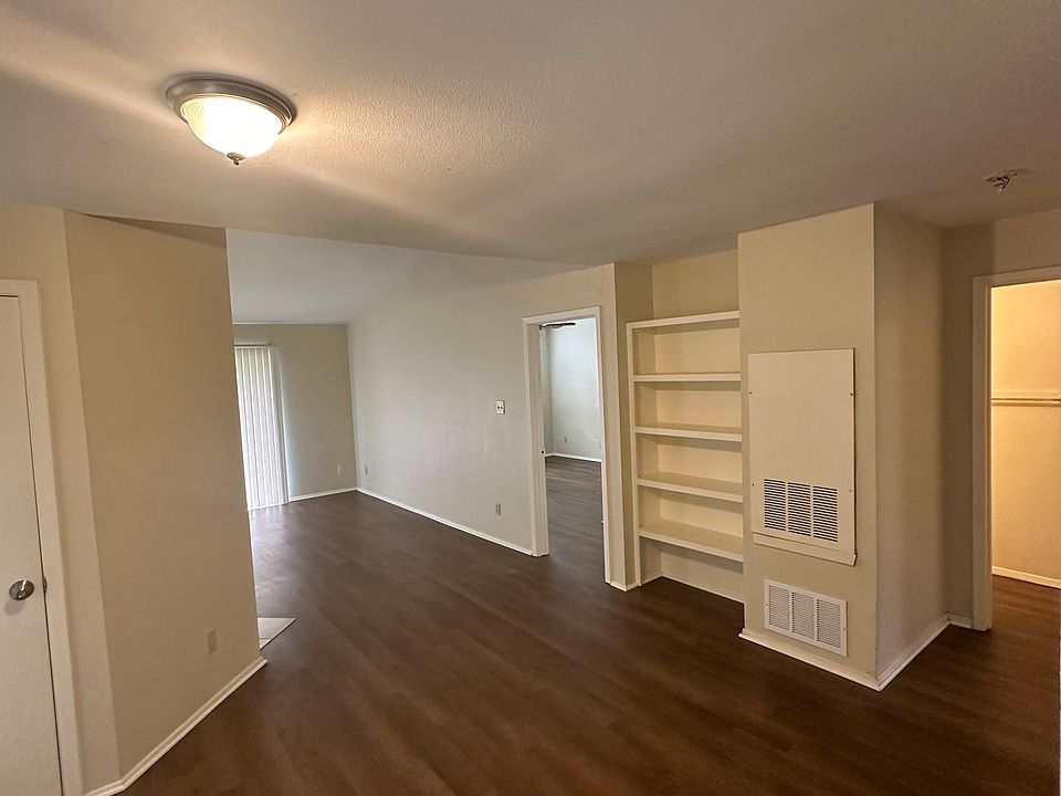 High ceiling, bookshelf, storage closet, luxury vinyl flooring
