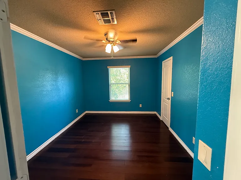 2nd bedroom with views of the trees and a walk in carpeted closet