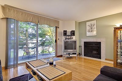 Open living room with wood burning fireplace.