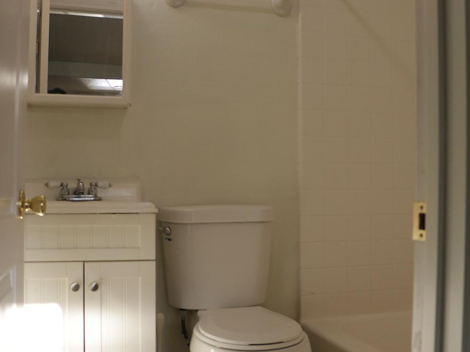 Studio Bathroom, which contains shower, tub, toilet, vanity/sink and tiled floor.
