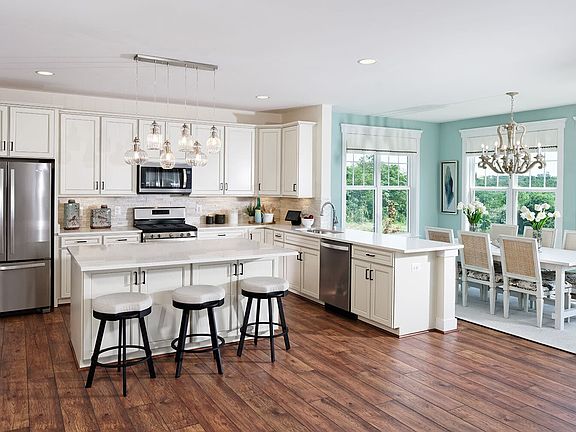 The kitchen and sunroom as modeled in the Summerfield by Brookfield Residential