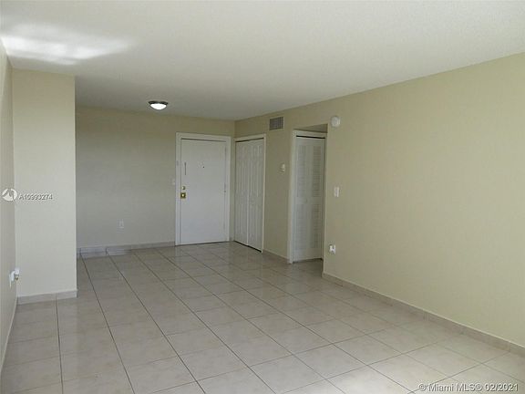 living-dining area fully tiled with front entry closet...