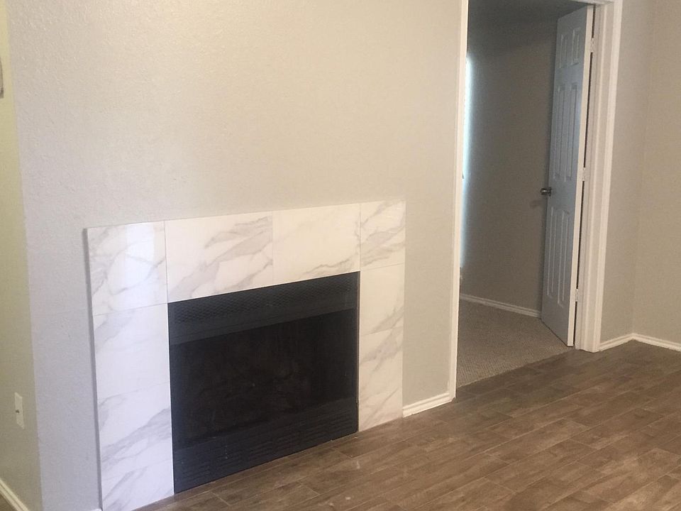 Beautiful fireplace new marble-look surround that compliments the fresh wall color and trim combination.