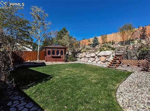 Beautifully landscaped and fenced back yard.  Enclosed hot tub for year round fun!